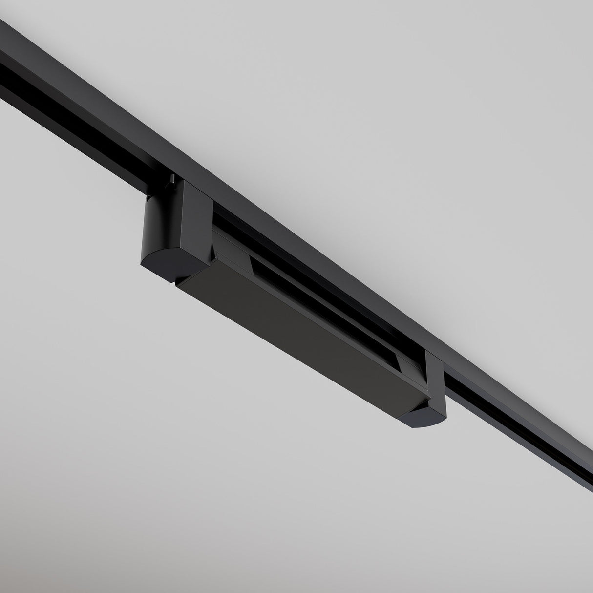 The Points Rot LED Swivel Linear Track Light (Black, 10W, 4000K, 36°) features a minimalist rectangular design on a white ceiling. It projects cool white light downward and is seamlessly secured along a single-phase track.