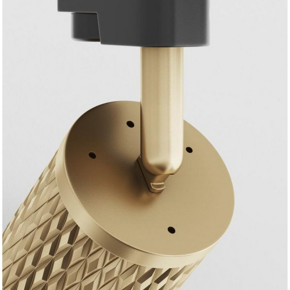 Close-up of the Focus Design Single Phase Unity Track Spotlight in gold, featuring a textured, cylindrical shape with a round base. It has a vertical metallic rod partially covered by a dark gray component and exhibits geometric details inspired by the Unity track system.