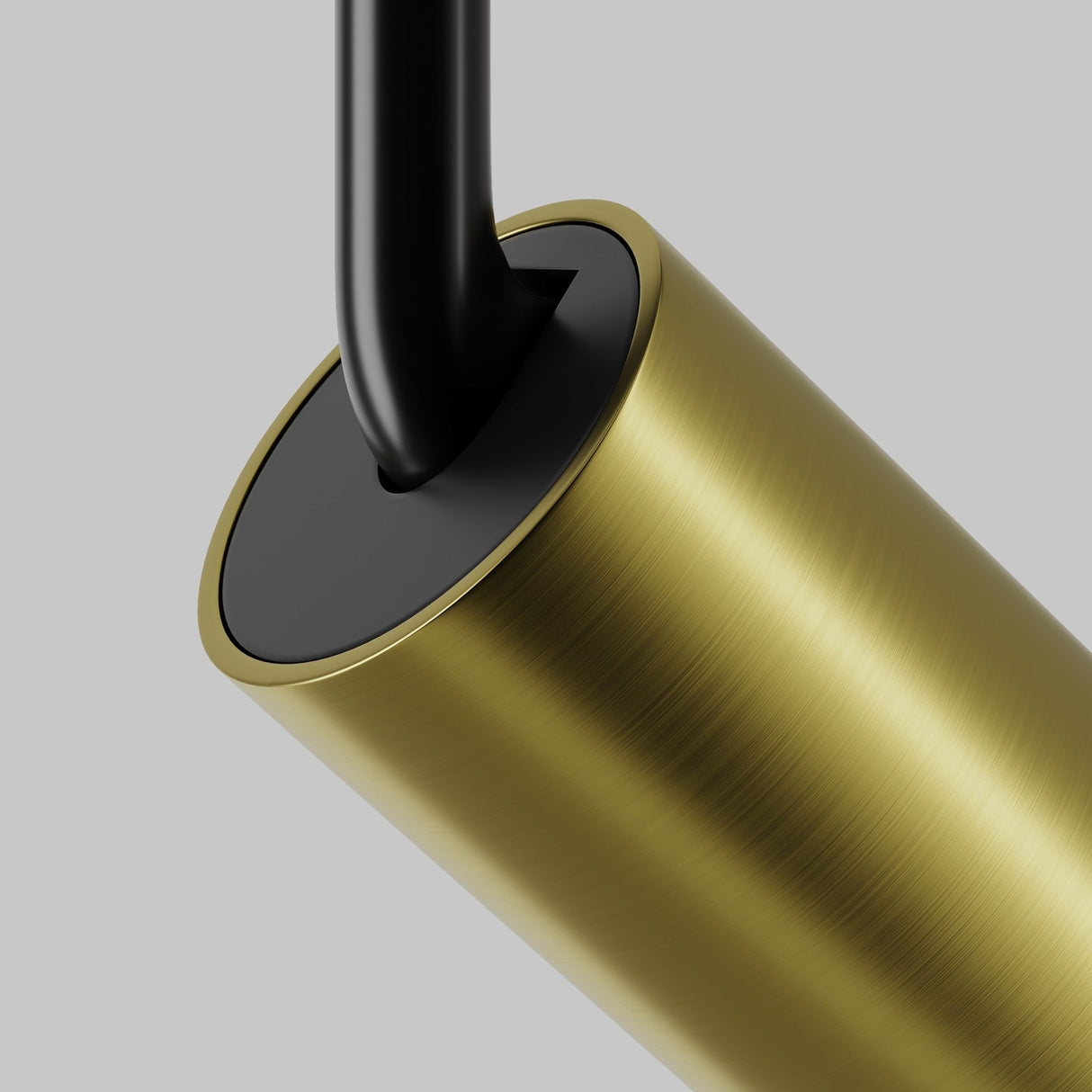 A close-up of the brass Focus LED CCT Magnetic Exility Track Spotlight 12W 2700-6000K, featuring a sleek cylindrical design with a textured finish, is attached to a smooth black rod against a light gray background.