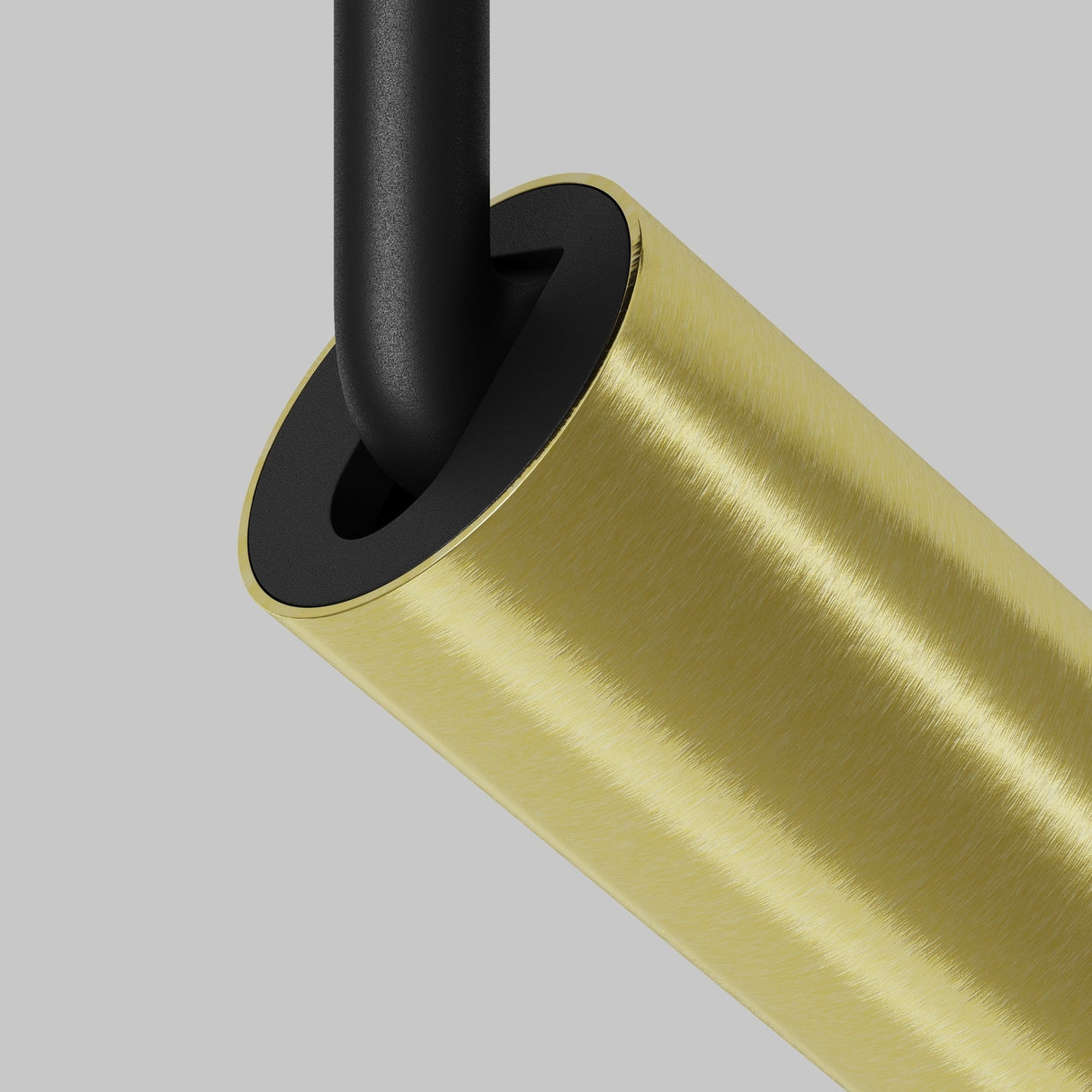 Close-up of the Focus LED CCT Magnetic Exility Track Spotlight 5W 2700-6000K, featuring a cylindrical brass body and black rod. The brushed brass texture adds elegance, while smart control lighting enhances functionality, set against a plain gray backdrop.