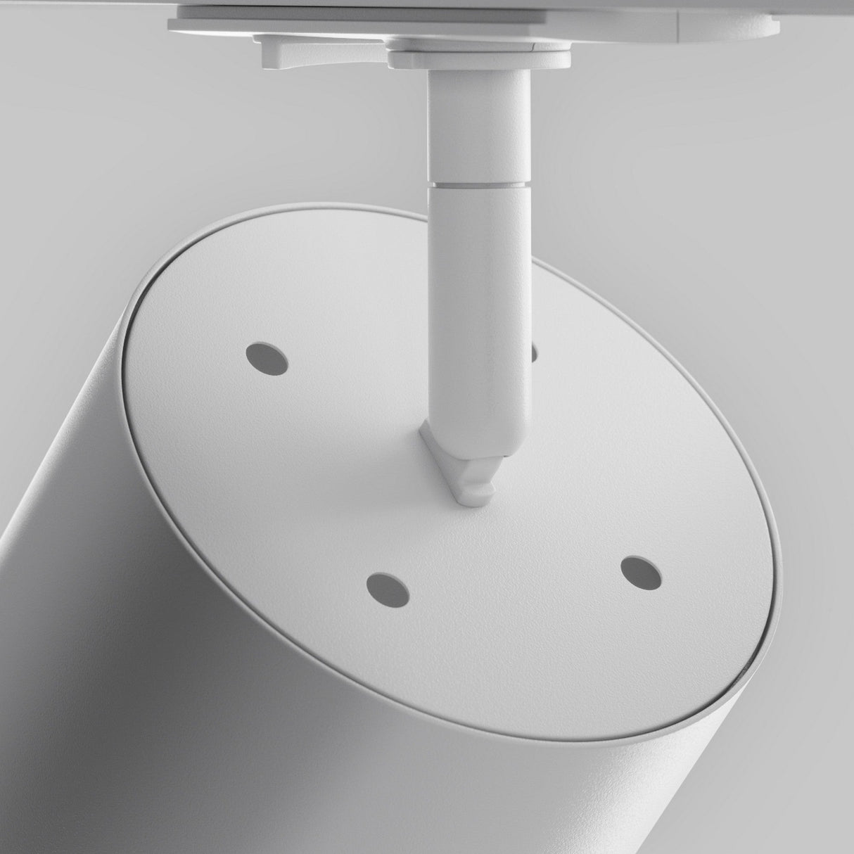 A close-up of the Polar LED Single Phase Unity Track Spotlight in white, designed for modern interiors with accent lighting. This minimalist cylindrical object features three small circular holes and a centrally attached stand against a simple gray background.