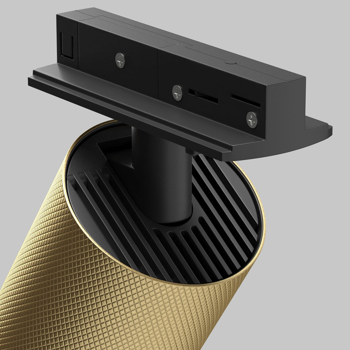 Close-up of the Artisan Single Phase Unity Track Spotlight in black and matte gold, with a textured handle, against a neutral gray background. The spotlight head is detached and displayed above the handle, highlighting its sleek design.