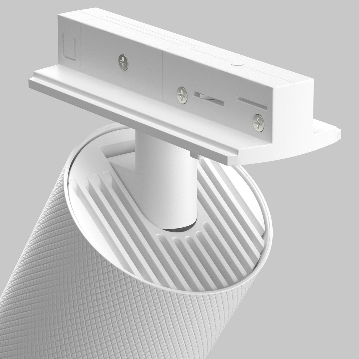 Close-up of an Artisan Single Phase Unity Track Spotlight - White, with a sleek cylindrical design and textured surface, mounted on a horizontal bracket. The background is a solid gray reminiscent of modern interiors.