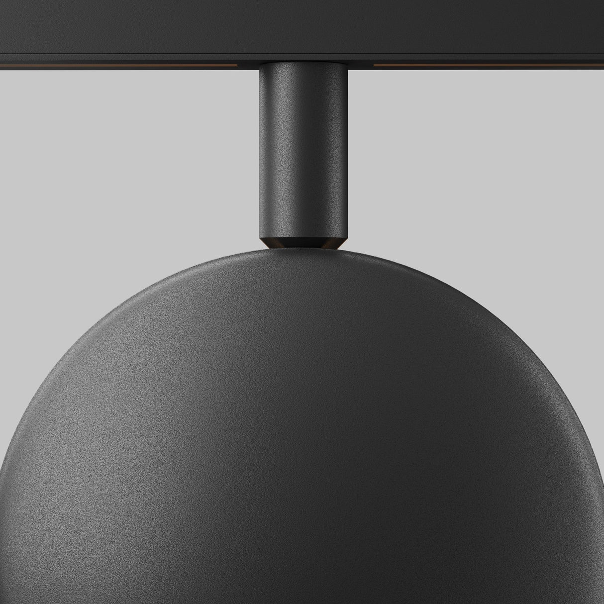 Close-up of the Outline CCT LED Dimmable Magnetic Exility Track Projection Light in matte black against a light gray background, featuring its minimalist design with a rounded shade and connecting rod, offering adjustable 2700-6000K lighting for customizable ambiance.