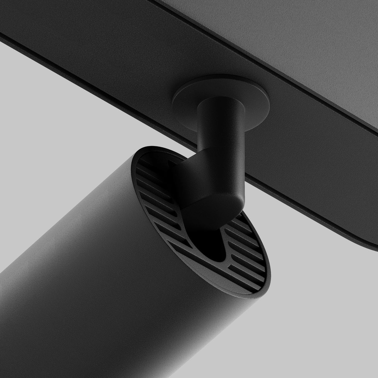 Close-up of the Focus LED Magnetic Radity Track Spotlight 5W in black, showcasing a sleek, modern adjustable hinge with a cylindrical, vented design reminiscent of industrial lighting against a plain gray background.