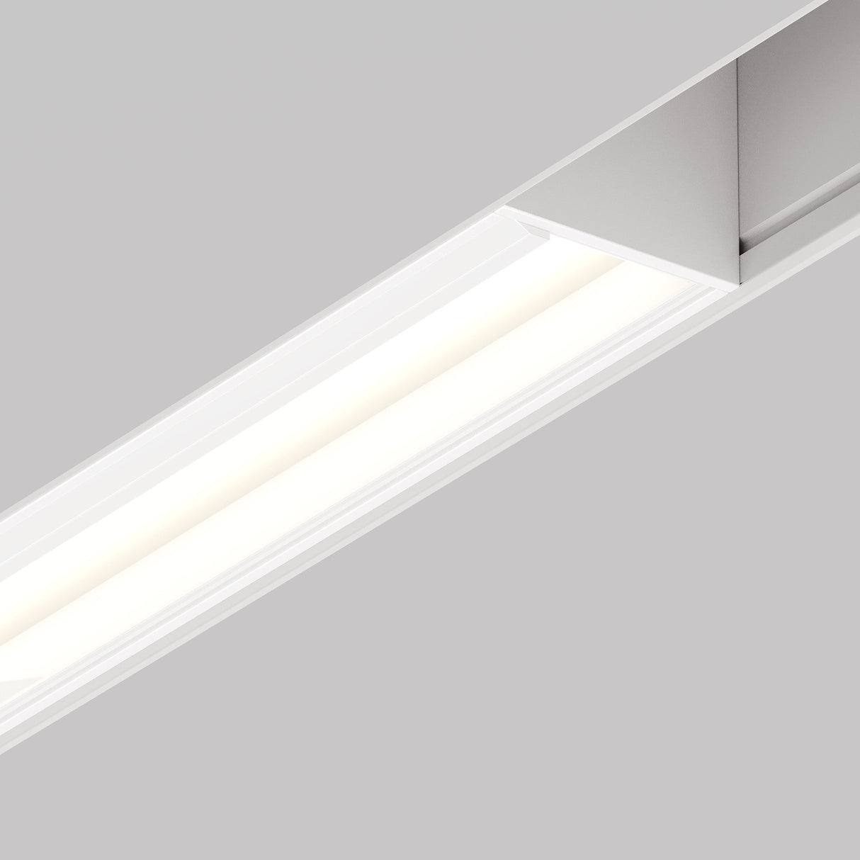 The Parete CCT LED Dimmable Linear Track Light for Magnetic Exility at 12W (2700-6000K) in white casts a bright, even glow on a light gray ceiling for a sleek, modern look.