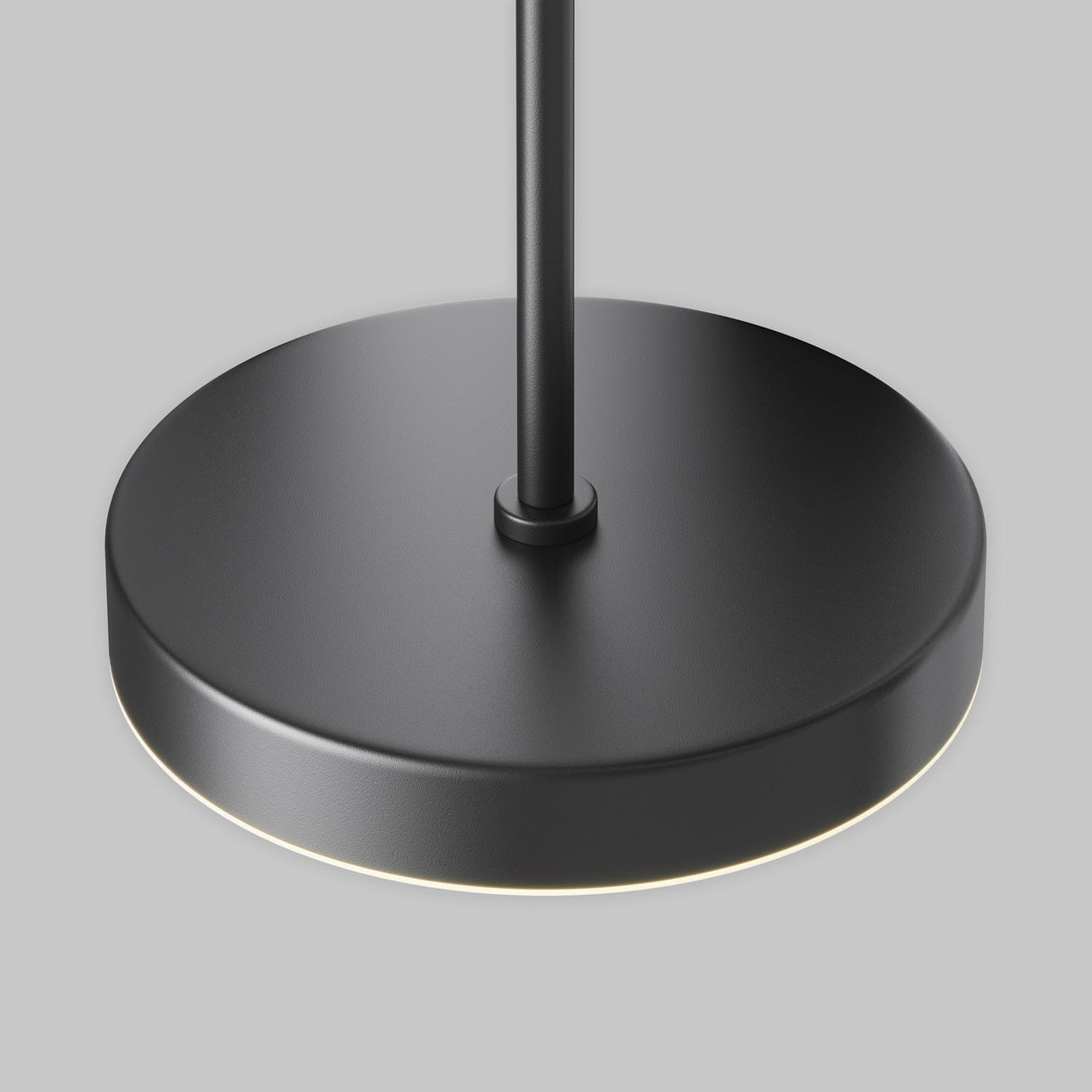 Close-up of the Plato CCT LED Dimmable Magnetic Exility Track Pendant Light, 15W in black. Featuring a circular base and slim vertical rod, it emits a soft glow with adjustable color temperatures (2700-6000K) for the perfect ambiance against a plain gray background.