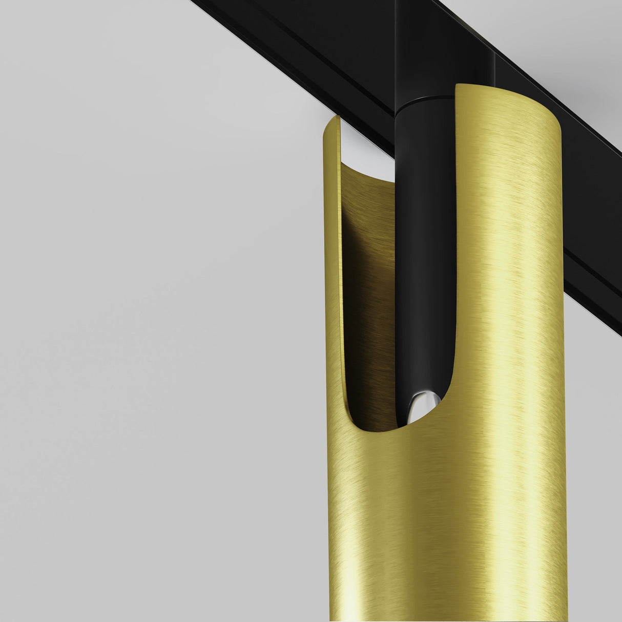 The Focus T LED Magnetic Exility Track Spotlight 6W 3000K features a black and brass design with a sleek, cylindrical gold casing. A vertical slot reveals part of the bulb, all set against a plain gray wall.