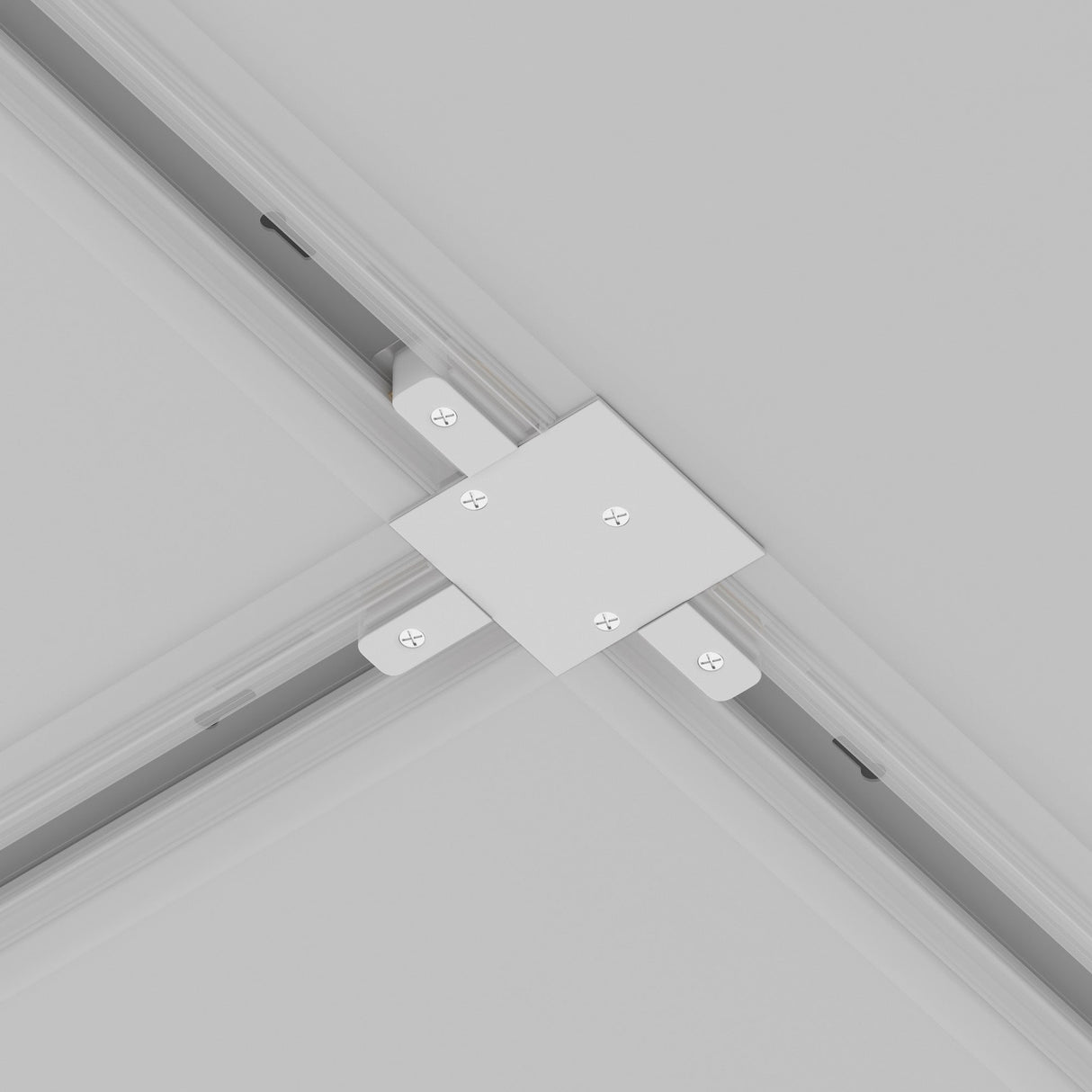 A close-up of the Unity Tracks Recessed T-Connector in white secures intersecting beams at a right angle with six visible screws on the light gray ceiling, forming a precise cross shape perfect for adaptable lighting configurations.