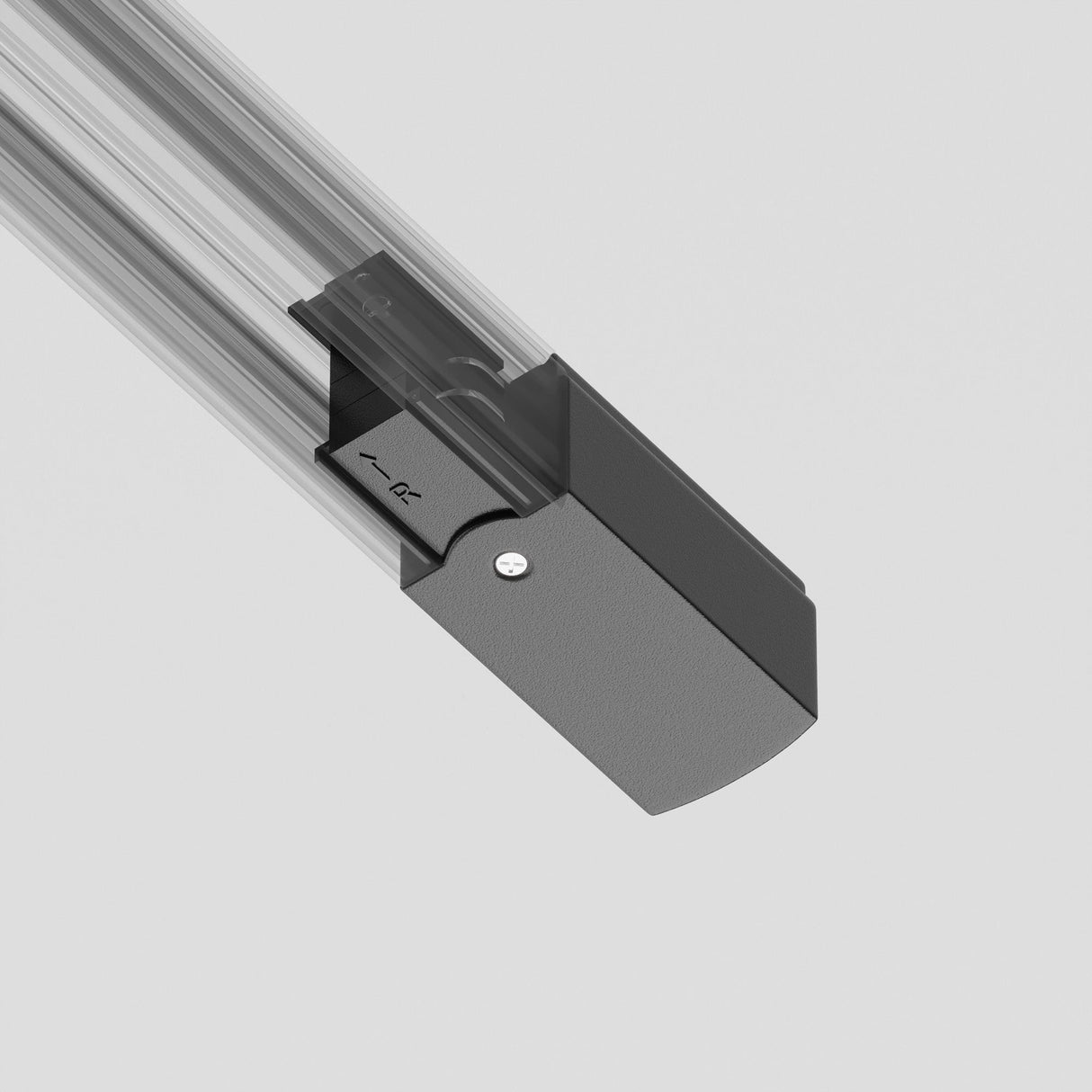 A sleek black and transparent component, likely the 3-Phase Track Trinity Right Power Input in black, is mounted on a light gray surface. Its smooth edges and minimalist design perfectly enhance modern interiors.