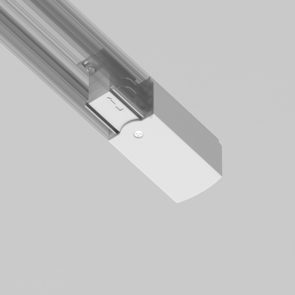 A modern 3-Phase Track Trinity Left Power Input fixture is mounted on the ceiling, featuring a minimalist rectangular casing with a metallic finish and durable plastic components, adding a sleek, contemporary look against the light gray background.