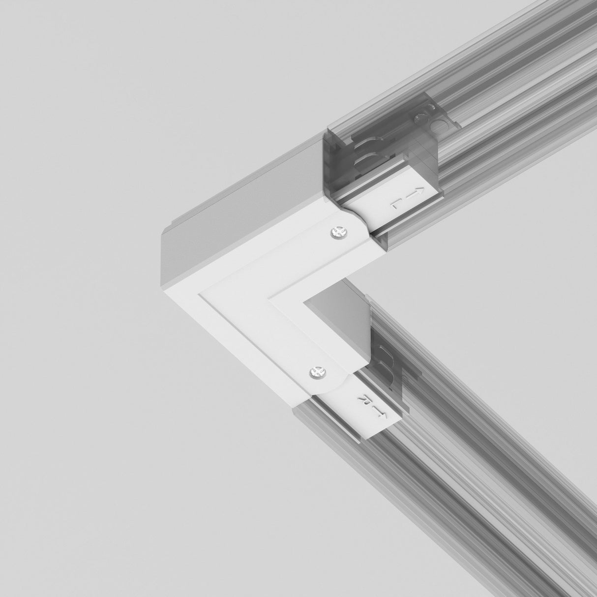 A close-up of a 3-Phase Surface-Mounted Track Trinity Left Corner Connector joins two linear beams at a right angle, secured with screws. The beams seem to be part of a structural frame, potentially for shelving or furniture assembly, set against a plain background.