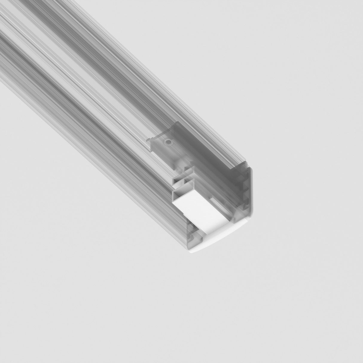 Close-up of a 3-Phase Surface-Mounted Track Trinity End Cap - White in a linear LED fixture against a plain white background. Its sleek, modern design features a rectangular shape with an exposed end cap that blends seamlessly with track lighting systems.