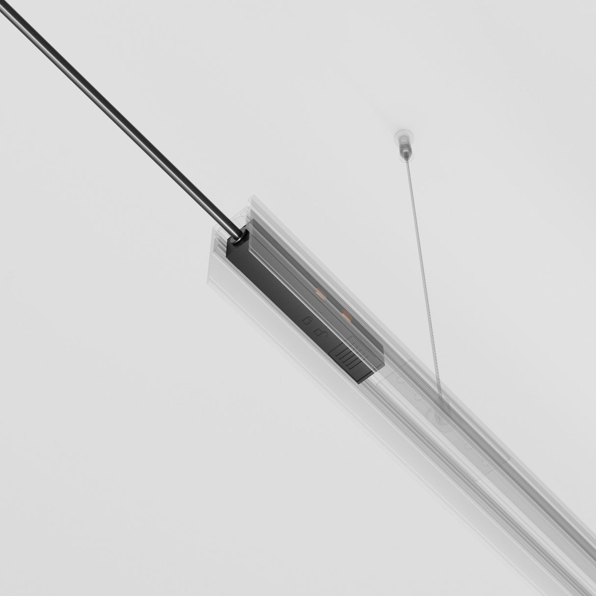 The Exility Track Power Feed - Black (TRA034B-42B) is a minimalist linear pendant light fixture, suspended by two thin cables against a white background. With its sleek design and modern aesthetic, it features a black power strip.