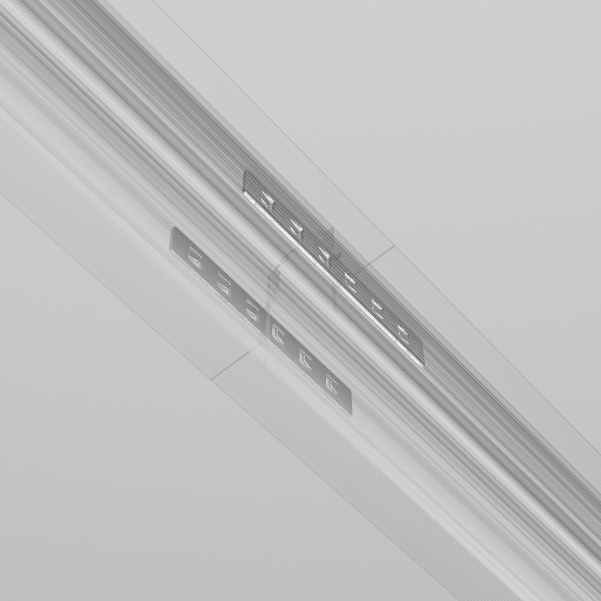 An abstract image with metallic gray plates featuring small rectangles, set against a blurred background. The scene evokes subtle sophistication akin to the Exility Tracks Recessed Straight Connector 2-Pack in Grey, with details as indistinct as recessed track lighting.