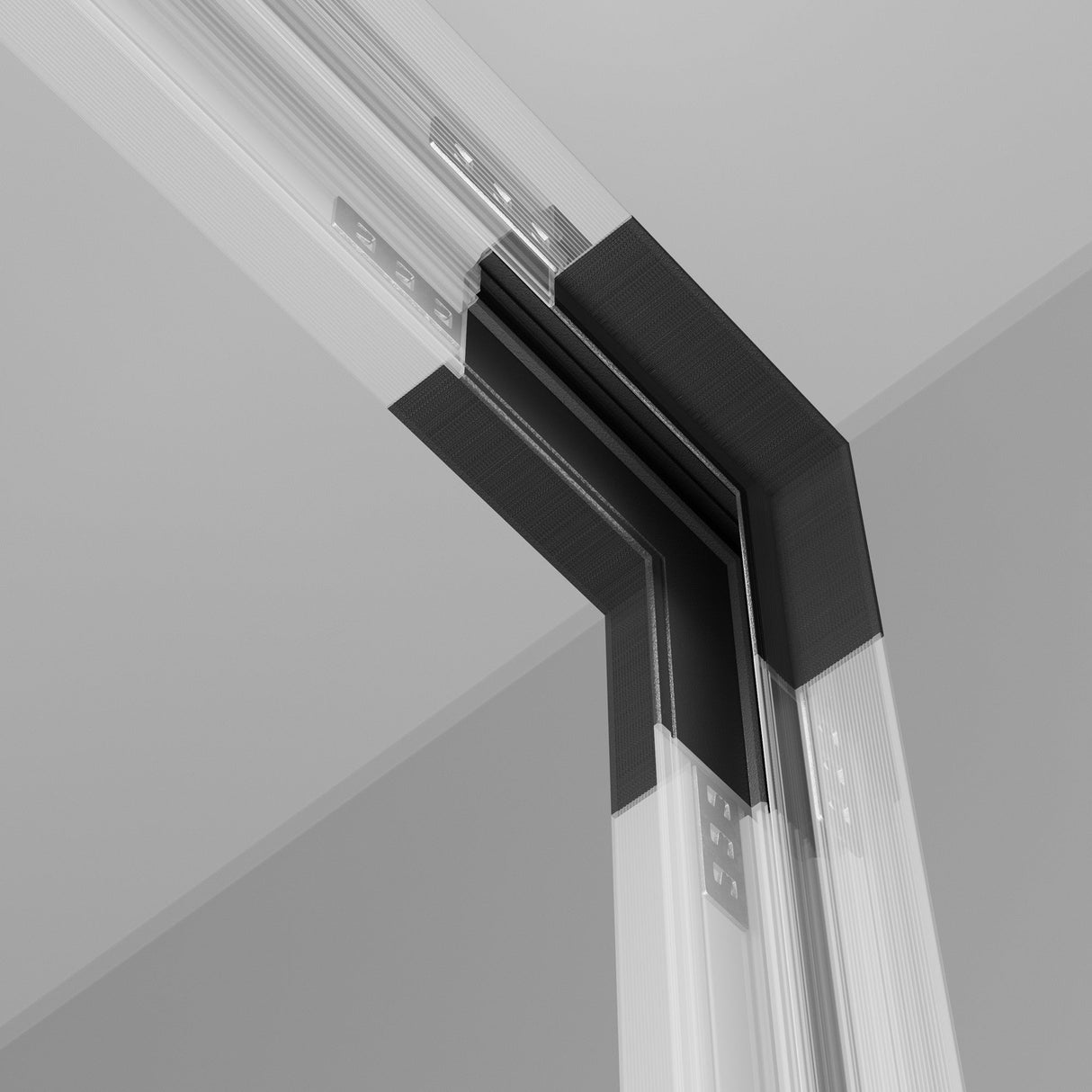 A close-up of the Exility Tracks Internal Corner Connector Built-in for Plasterboard 9.5mm in black, showcasing its precise construction and joints. The image highlights gray, black, and white structural elements, emphasizing modern architecture with recessed track sections for a sleek design.