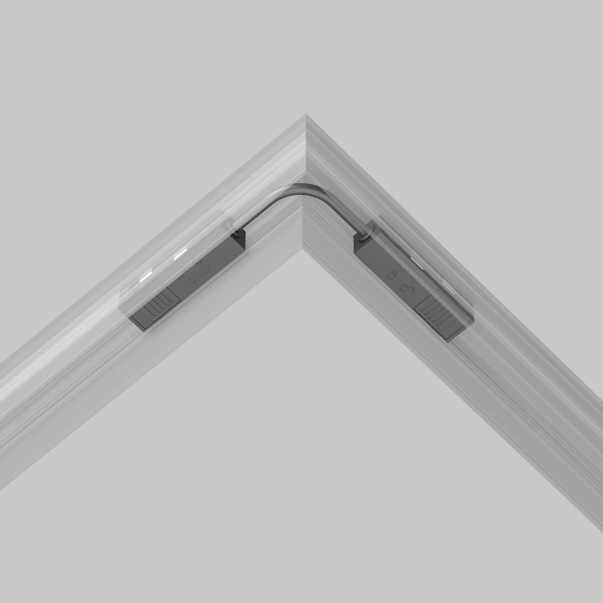 In the corner of a gray room, the Exility Track Flexible Corner Power Connector 15cm - Black joins sleek track lighting sections at a right angle. Its sophisticated and minimalist design seamlessly complements the space.