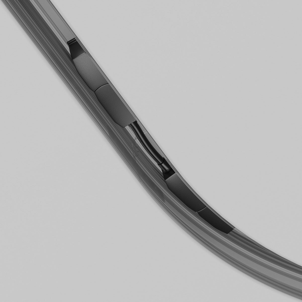 Close-up of a black, curved component against a light gray background, showcasing detailed segments and joins along the curvature, reminiscent of an Exility Magnetic Recessed Track Corner Oval Connector - Black.