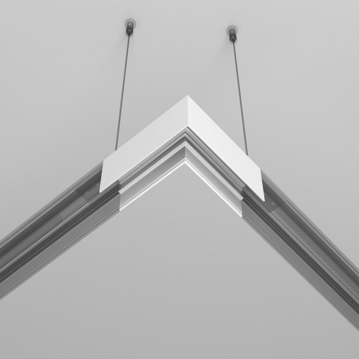 The Exility Magnetic Surface-Mounted Track Corner Connector in white is a sleek, modern linear LED fixture elegantly suspended by two thin cables against a plain white background.