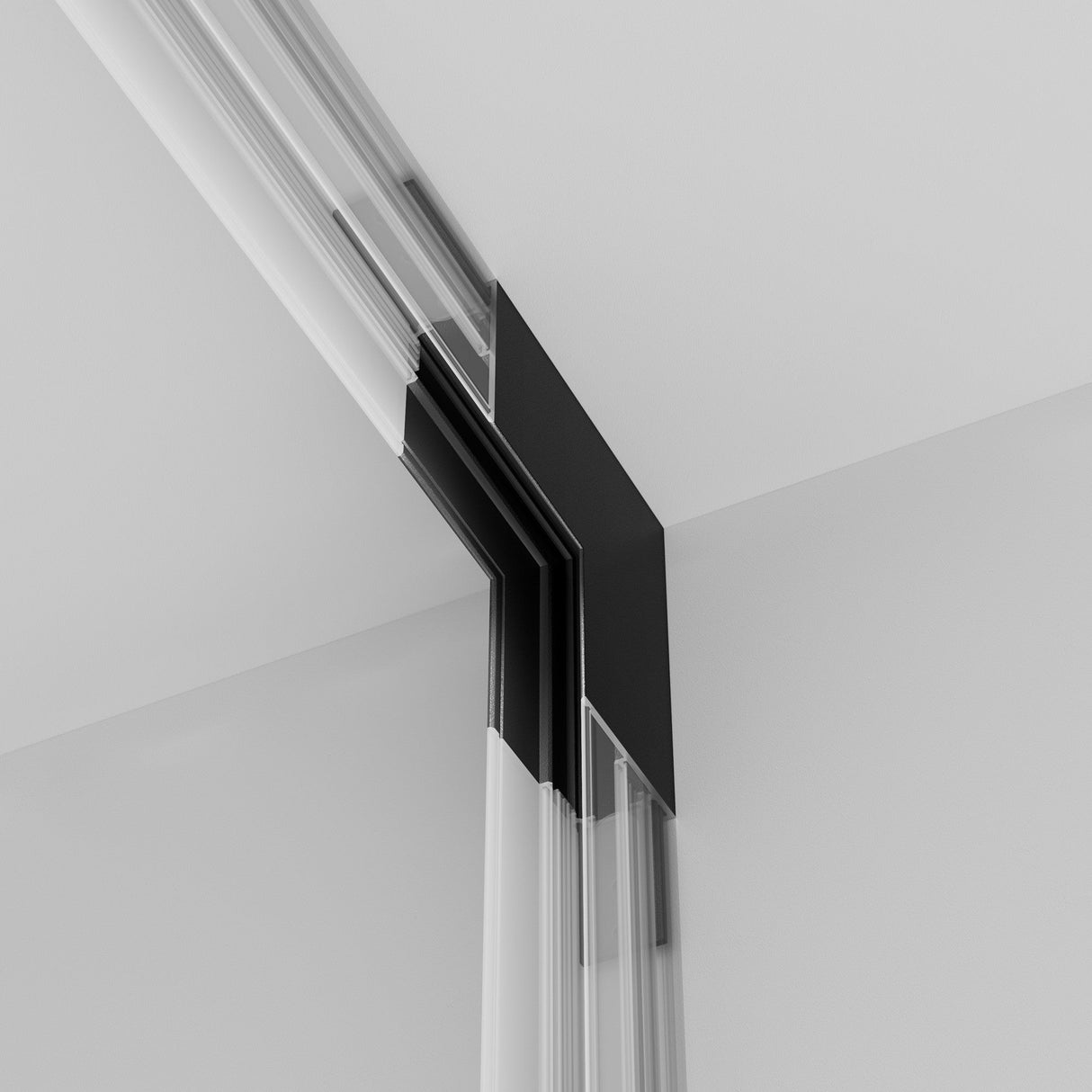 Close-up of an Exility Magnetic Surface-Mounted Track Internal Corner Connector in black, integrated into a sleek sliding glass door frame. The minimalist interior features smooth white walls and ceiling, accentuating the recessed doors sophisticated design against the bright background.