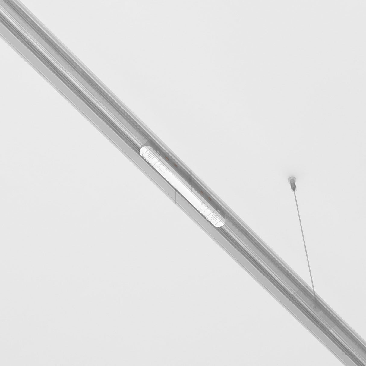 The Exility Track Straight Power Connector in white is suspended from a white ceiling with thin wires. Its sleek, minimalist design seamlessly integrates with the unobtrusive background, highlighting the simplicity of the architectural feature.
