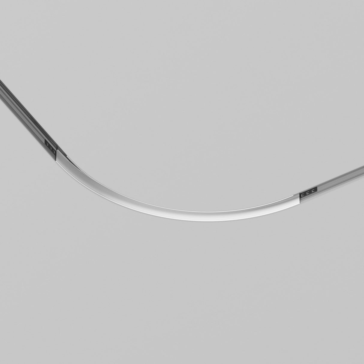 A sleek, curved metallic object on a light gray background resembles the Exility Tracks Radius Connector R300 Built-in for Plasterboard 12.5mm in White. It features parallel black lines on one side and boasts a minimalist design.