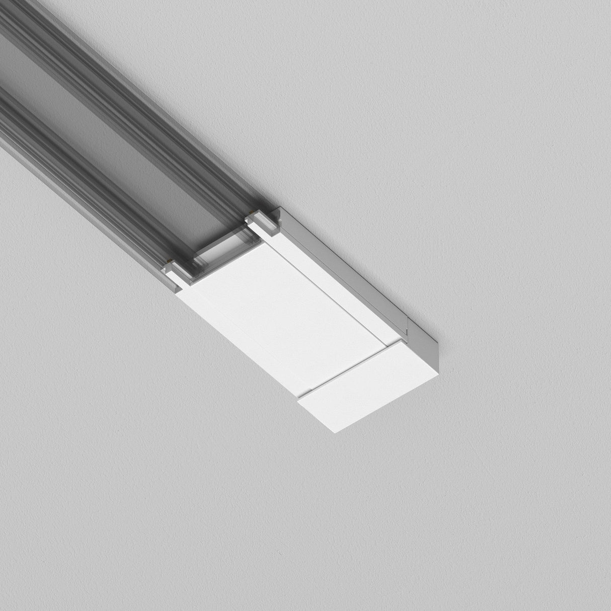 The Radity Magnetic Track Surface Power Feed in white is a modern rectangular ceiling light fixture featuring sleek silver accents and multiple metal rods for seamless ceiling connection, ideal for minimalist interiors with its clean lines against a plain background.