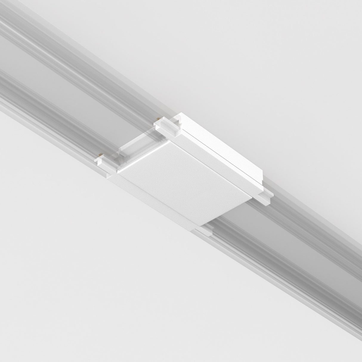 A white Radity Magnetic Track Straight Power Connector is mounted on a light gray ceiling track, indicating it may be part of a lighting or electrical installation system.