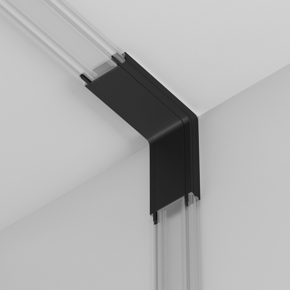 The Radity Magnetic Track Power Connector Internal in black is mounted on a white ceiling and wall, forming a clean corner angle. Its sleek design is minimalist and modern, seamlessly integrating with the interior.