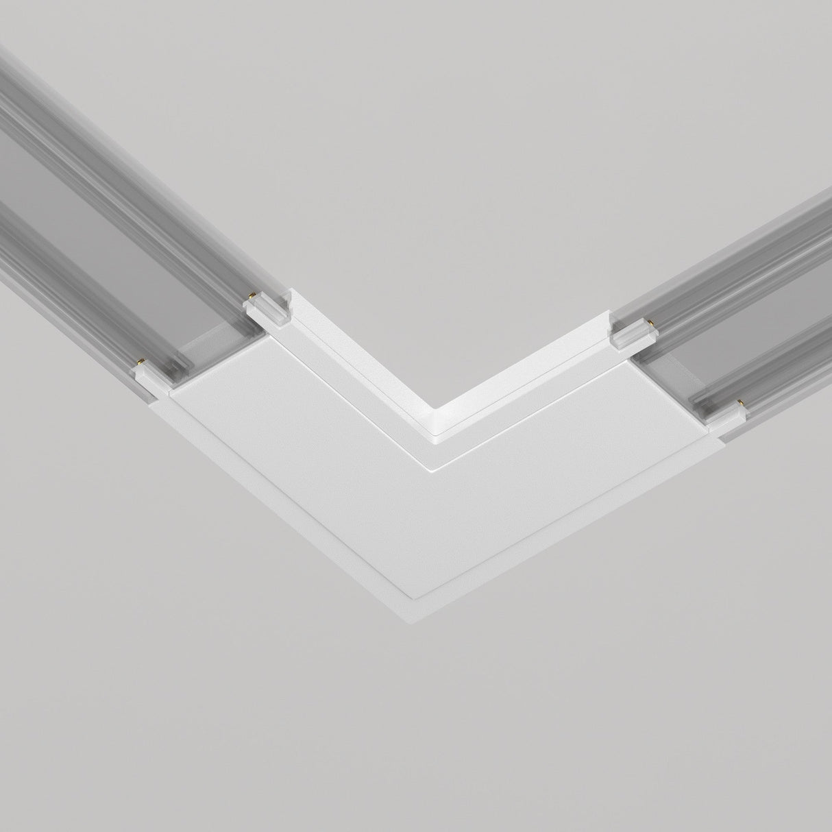 A minimalist architectural detail showcases a white, L-shaped Radity Magnetic Track Power Connector seamlessly integrated into a gray ceiling. The sleek design emphasizes sharp, clean lines and geometric form for a modern touch.