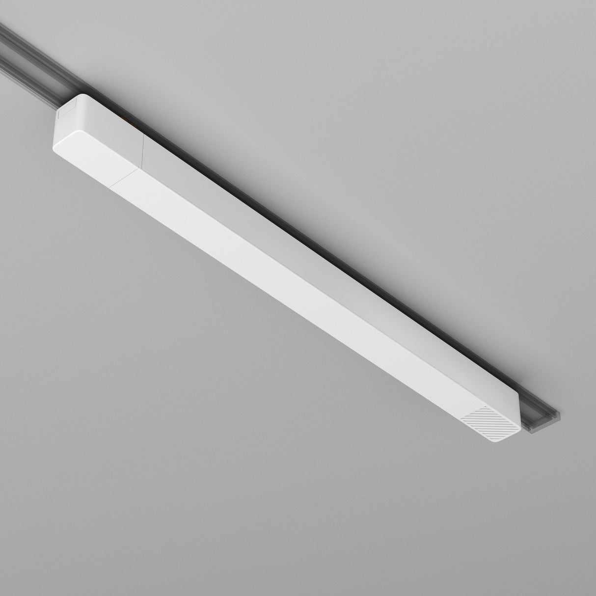 The Radity Track Power Supply 200W - White is a sleek, modern LED light fixture mounted on a gray ceiling. Its long rectangular design offers a minimalist look with an integrated recessed power supply, seamlessly blending into the magnetic track systems of the ceiling.