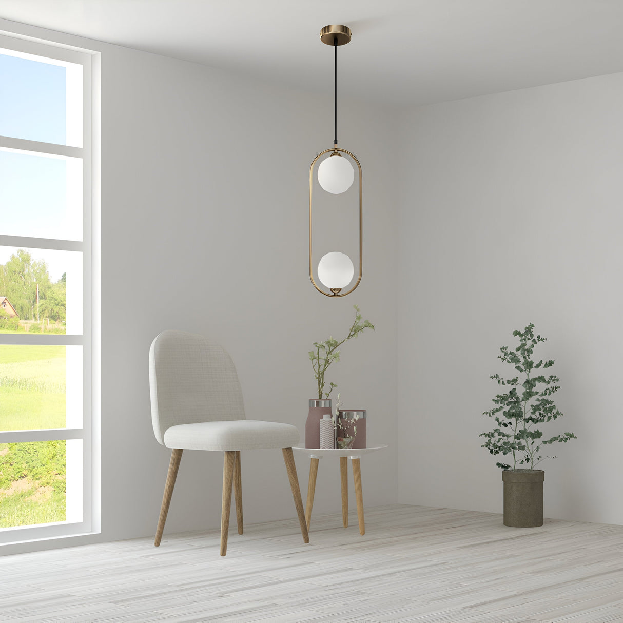 A minimalist room includes a white chair, small round table with plant vases, and the Ring 2 Light Pendant in brass with white glass spheres hanging at adjustable height. A large window frames outside greenery while a floor potted plant adds to the serene ambiance.