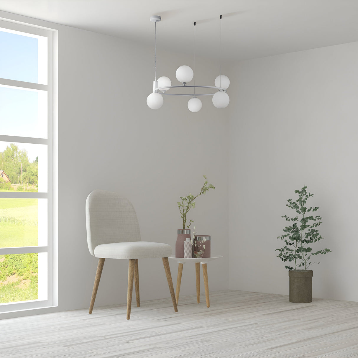 A minimalist space with a white chair, small round table, and potted plants on a light wooden floor is enhanced by the Ring 6 Light Circular Suspension in white, featuring spherical bulbs. A large window frames outside green fields for a contemporary look.