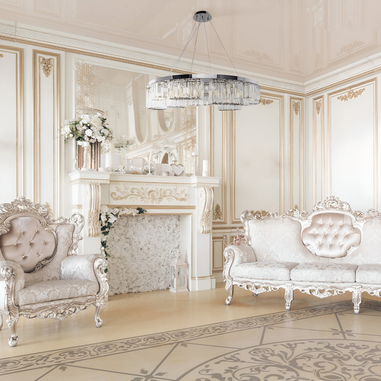A luxurious living room features ornate white and gold furniture, including two carved armchairs, a matching sofa, and a decorative fireplace with floral arrangements. The elegant decor is complemented by the Colline 9 Light Suspension in Chrome with shimmering glass pendants.