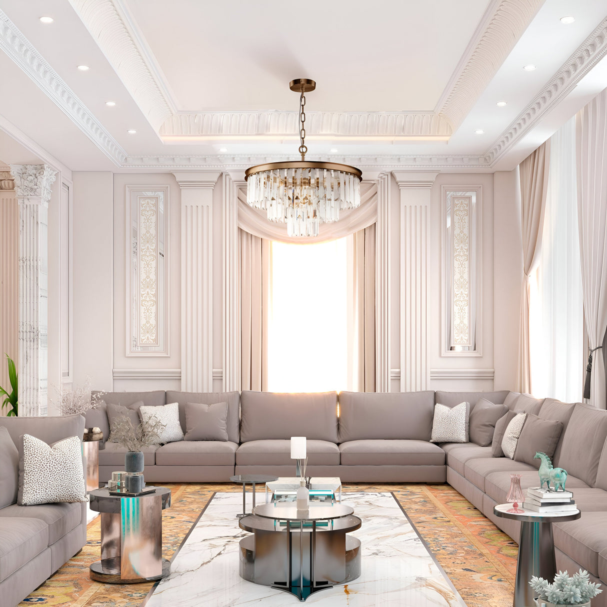 Luxurious living room featuring a large U-shaped beige sofa, marble floor, decorative rug, and modern glass coffee table. The room is illuminated by the Revero 7 Light Chandelier - Brass adorned with crystal pendants and natural light from a large window with elegant curtains.