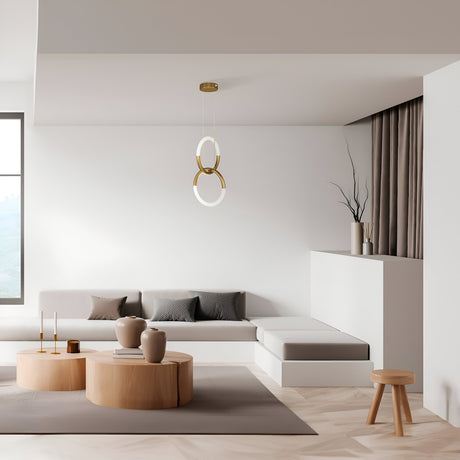 In a minimalist living room, a beige sectional sofa with gray cushions complements the Node LED 2 Rings Pendant Light - Gold, which casts modern elegance over a round wooden coffee table adorned with vases. Natural light flows through the window, enhancing the neutral decor.