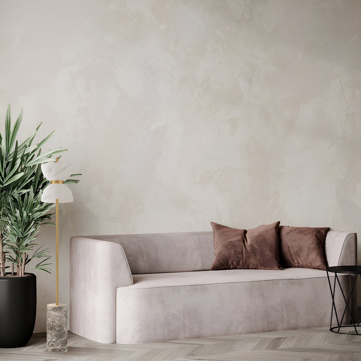 A minimalist living room features a light gray sofa with two brown cushions. On one side, theres a Kyoto LED Floor Lamp - Gold & Grey and a large potted plant; on the other side, a small black side table. The Japanese-inspired background highlights a textured beige wall.