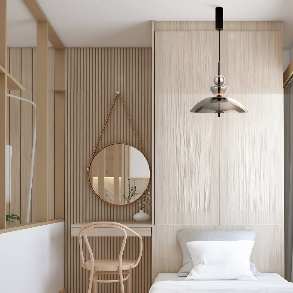 A minimalist bedroom boasts a bed with white linens, a wooden chair, and a round mirror on a slatted wooden wall. The Bangkok LED Pendant Light in black with a smoky glass shade hangs from black metal hardware, casting soft light. A small plant on the wall shelf offers greenery.