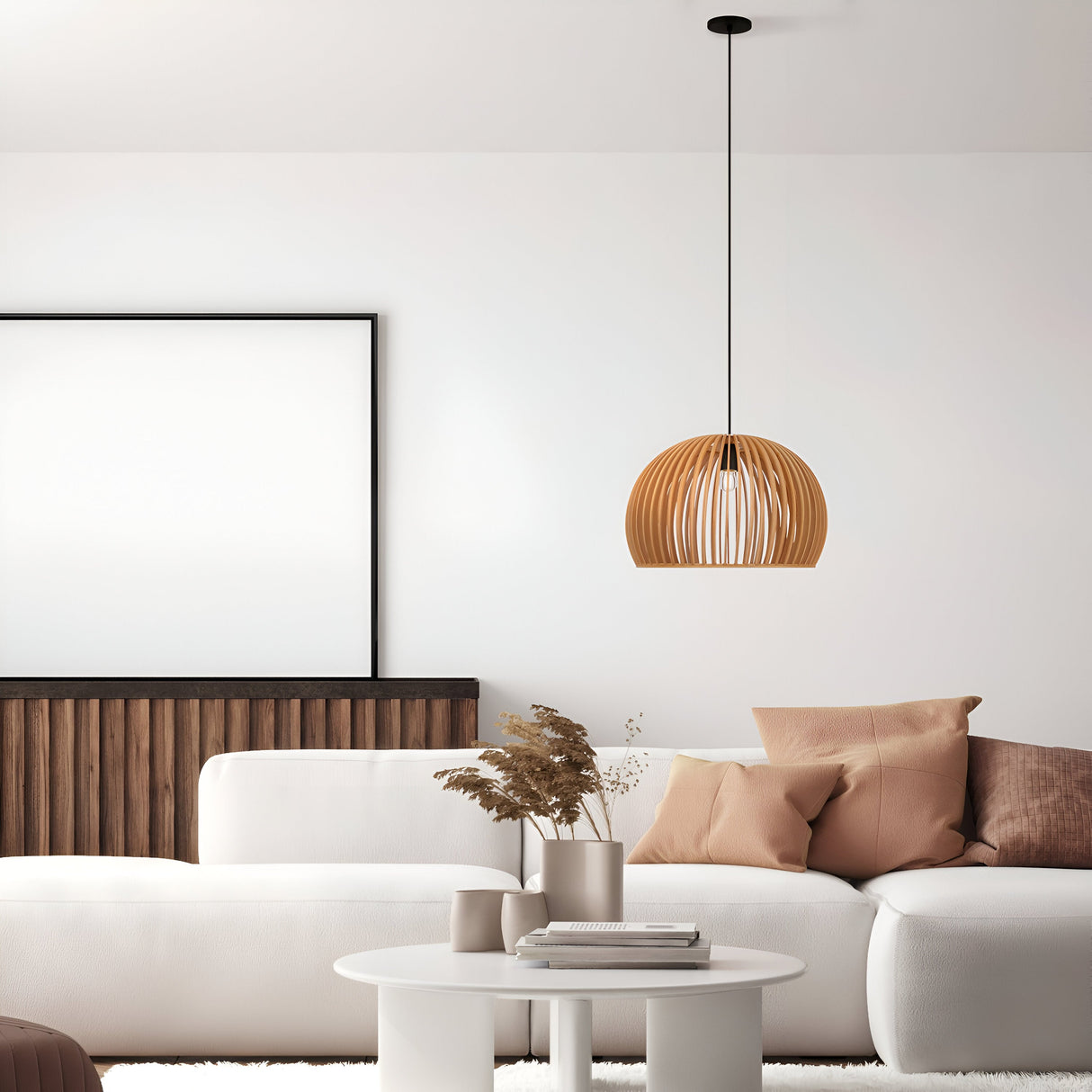 The minimalist living room showcases modern design with a white sofa, brown cushions, a round coffee table with dried plants, and a beige wooden globe dome. The Roots Pendant Light 33cm Black With Beige Wooden Half-Dome Shade elegantly complements the wood paneling and blank wall frame.