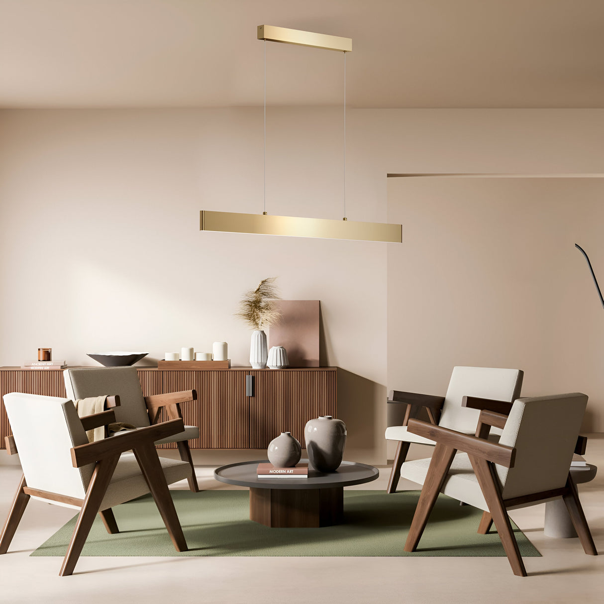 In a minimalist living room, four modern wooden chairs surround a circular coffee table, illuminated by the Step LED Linear Suspension Light 3000K 23W - Gold. A sideboard against a neutral wall holds decorative vases and candles, with the gold finish adding elegance to the serene space.