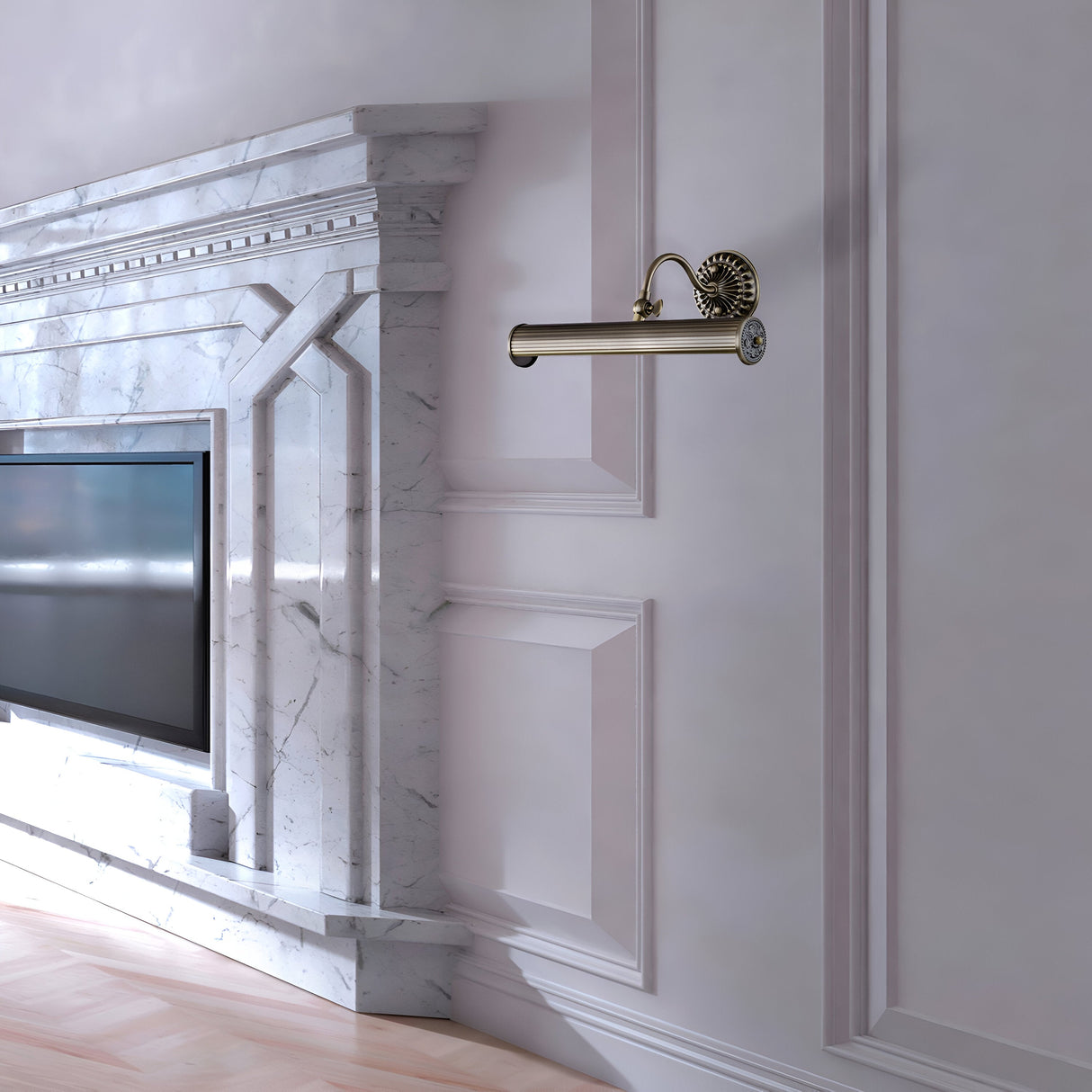 A luxurious living room includes a large marble fireplace with intricate details, flanked by a stylish bronze wall sconce. A flat-screen TV is mounted on the wall, highlighted by a Renoir Classic Picture Light - Bronze above it, while the walls feature elegant white paneling for added refinement.