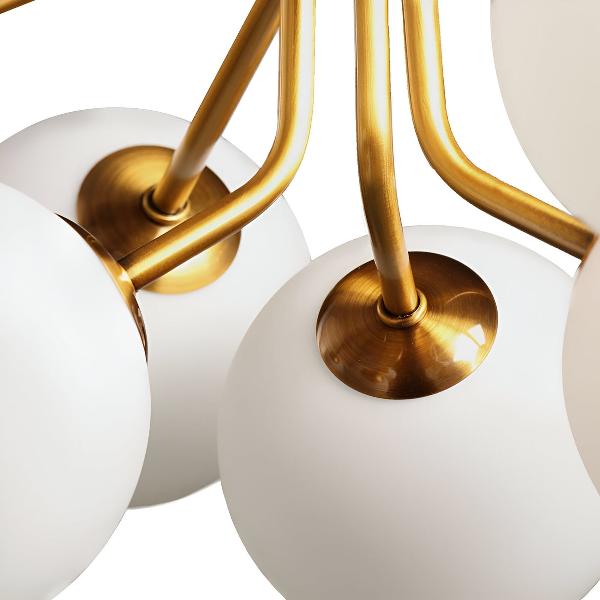 Close-up of the Ivy 9 Light Chandelier - Brass with white frosted glass globes and gold arms, set against a white background for a botanical-inspired look.