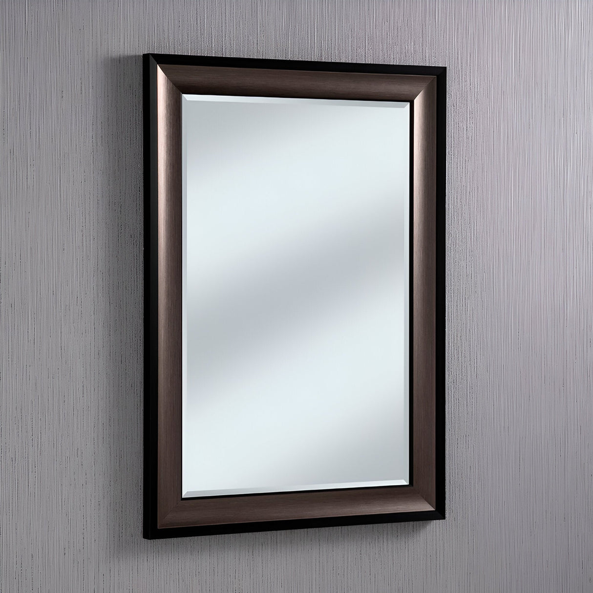 The Liberty Rectangle Wall Mirror - Black & Brushed Grey is mounted on a textured, light-gray wall. Its frame features both black and brushed grey tones, softly reflecting light to accentuate its modern design with a subtle shine.