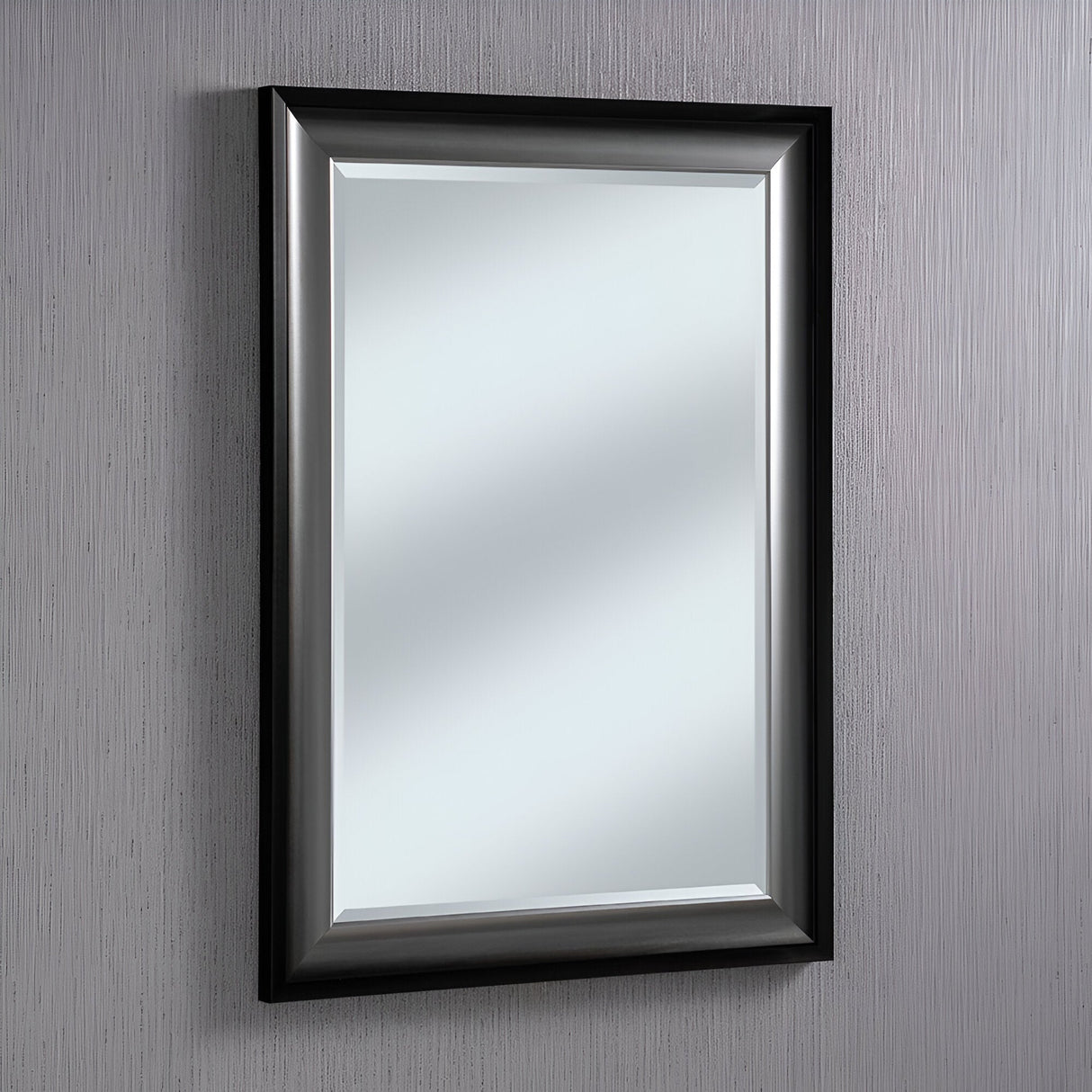 The Liberty Rectangle Wall Mirror - Gloss Black & Gunmetal Grey Silver introduces modern elegance to any space. Installed on a textured gray wall, it beautifully reflects light, offering a bright and versatile enhancement to your décor.