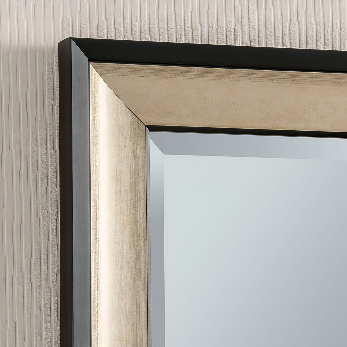 Discover the elegance of the Liberty Rectangle Wall Mirror - Champagne, featuring a sleek modern design and a chic champagne-colored frame. This mirror epitomizes luxury in home decor. When mounted on a textured, light-colored wall, it exquisitely reflects soft ambient light, enhancing any space with sophistication.