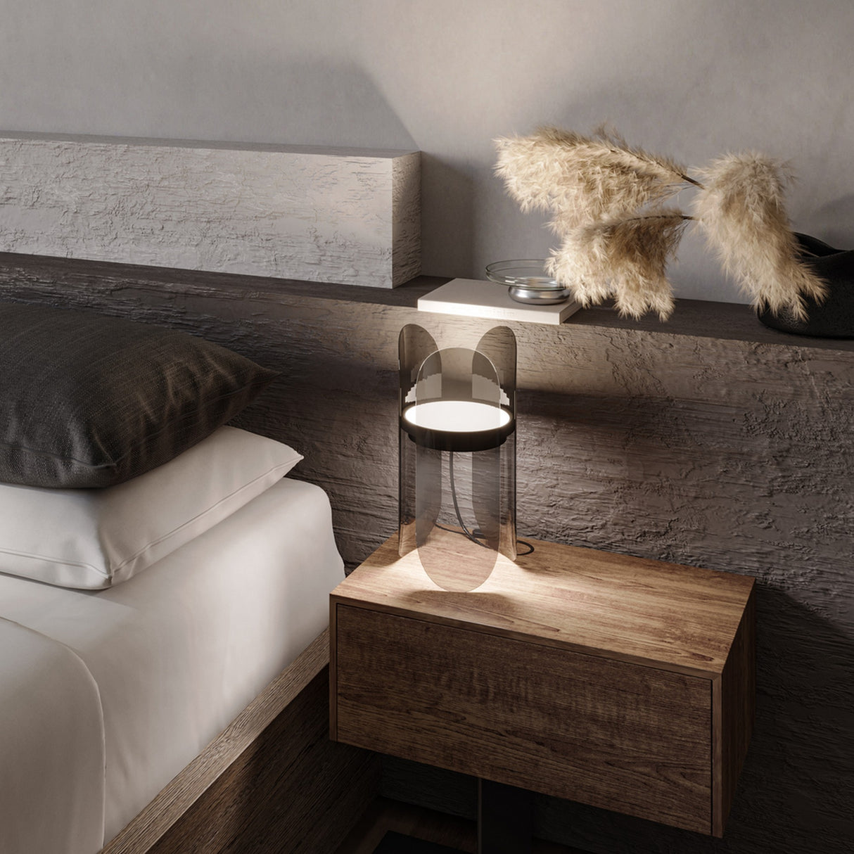 A minimalist bedroom showcases a wooden nightstand beside the bed, topped with an Insight LED Table Lamp - Black with a translucent shade and a vase of dried pampas grass. The textured wall finish enhances the cozy ambiance, highlighted by modern lighting.