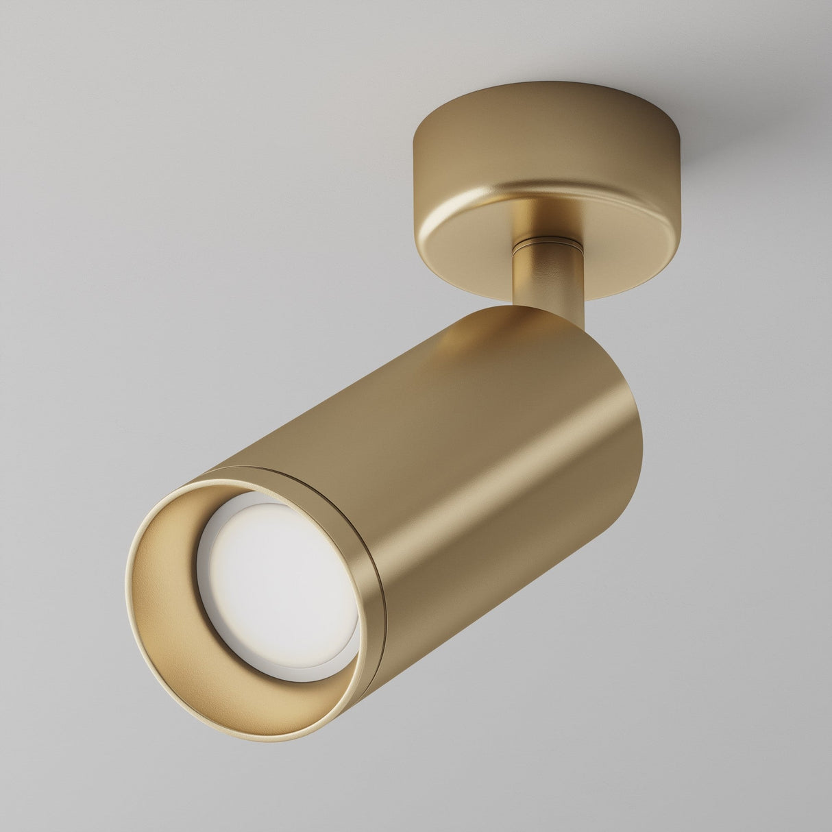 The Focus Single Surface-Mounted Spotlight in Matte Gold features a modern cylindrical design with a round ceiling base. Its adjustable lighting offers a sleek, minimalistic appearance, ideal for any contemporary space.