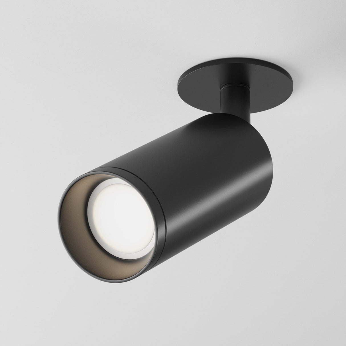 Close-up of the Focus Single Recessed Spotlight in black with a contemporary design. This sleek cylindrical fixture on a round base casts adjustable downward light, creating a striking contrast against the white ceiling.