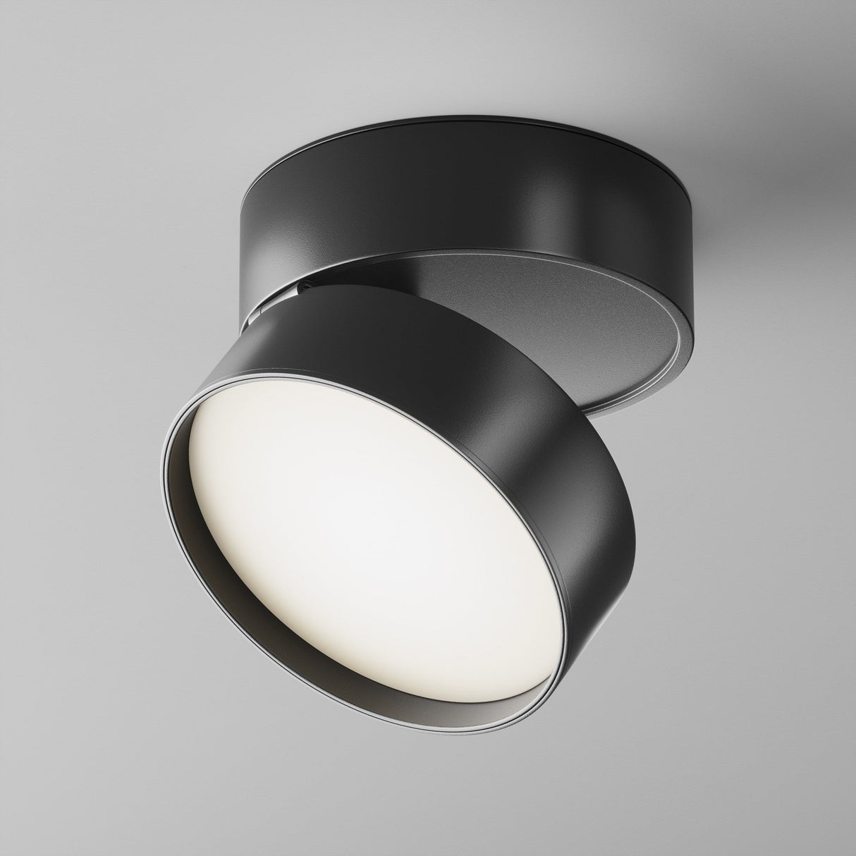 The Onda LED Single Spotlight, 18W in black, offers a modern design with a cylindrical shape and partially exposed 4000K bulb. Its mounted on a white ceiling with an adjustable head for precise lighting.