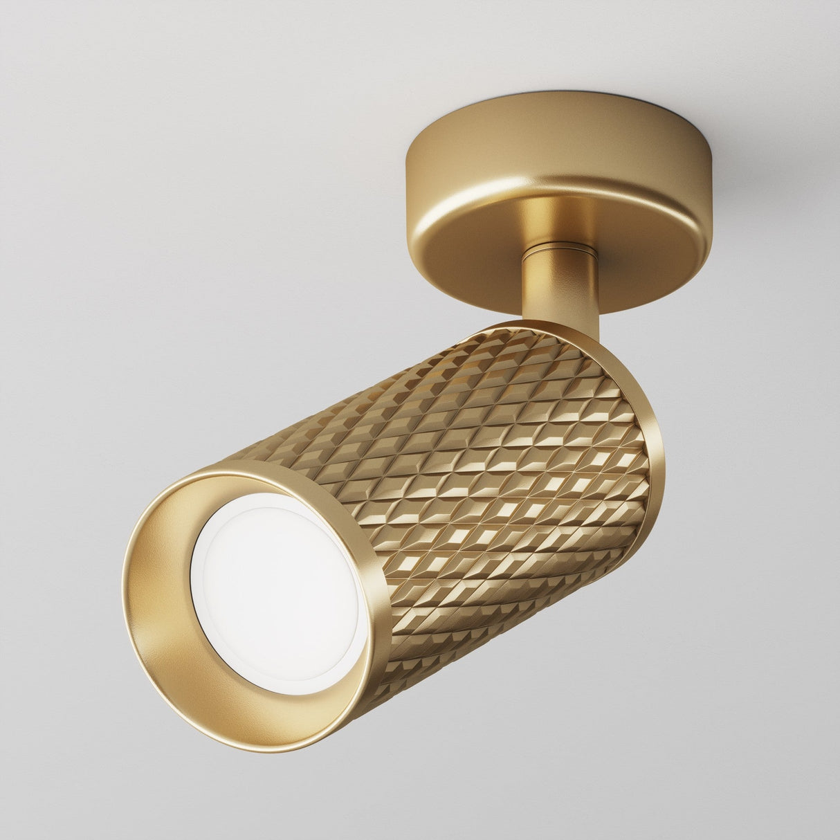 The Focus Design Single Spotlight in matte gold is ceiling-mounted with a textured cylindrical design and features a swivel mechanism for precise downward accent lighting.